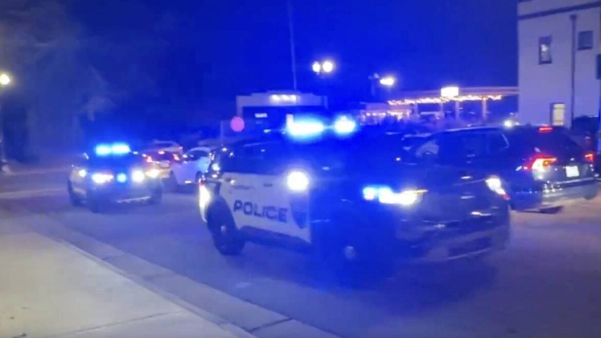 PHOTO: Several police vehicles sound sirens after reports of shots fired at Christmas Tree Lighting in Concord, North Carolina.